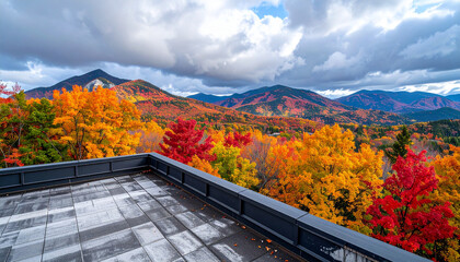 Naklejka premium Rooftop balcony overlooks a vast expanse of colorful autumn trees and distant blue mountain ranges