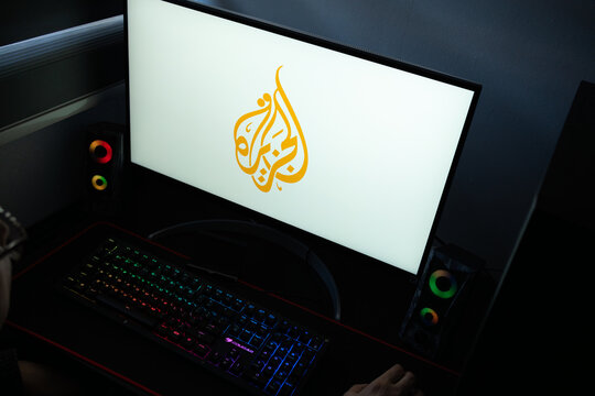 Punta Arenas, Chile &ndash; January 20, 2026: Al Jazeera news network logo displayed on a computer monitor in a dark room with RGB lighting