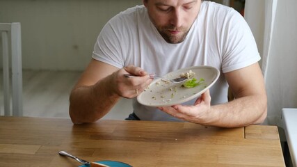 6 years old boy eats instant noodle from box. Child is eating Asian ramen. Lunch time. A good appetite. Tasty children food. Close-up portrait. Carbs dinner. Fast food. Kid eating by himself with fork