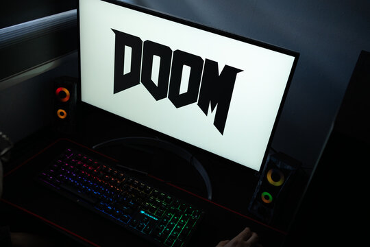 Punta Arenas, Chile &ndash; January 20, 2026: DOOM video game franchise logo displayed on a computer monitor in a dark room with RGB lighting