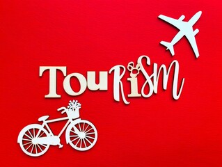 Text tourism, wooden airplane and bicycle symbol on red background.