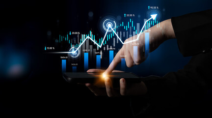 A close-up of a hand interacting with a touchscreen device, analyzing stock market trends through dynamic data visualizations and a growing graph in a dark background. Scalp