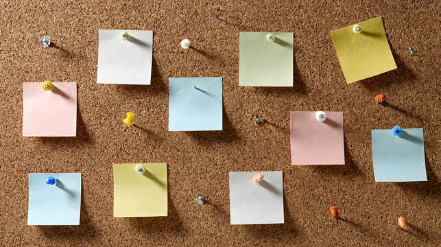 Colorful sticky notes pinned on a cork board background