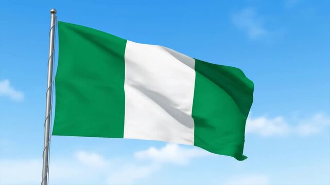 Waving Nigerian Flag - The national flag of Nigeria waves proudly against a bright blue sky with a few light clouds. The flag has three vertical bands of green, white, and green.