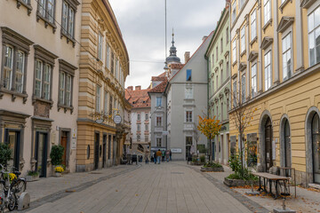 Naklejka premium Graz, Austria - 10.19.2025: Colorful Historic Street Scene in Graz Old Town, Austria