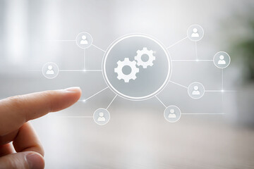 Hand pointing at gears in a digital people network