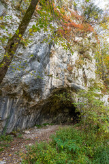 Fototapeta premium Rock Cave and Emerald Lake at Plitvice Lakes National Park in Autumn, Croatia