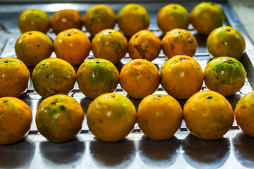Closeup of orange fruit on kitchen sink