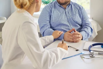 Fototapete Altes Krankenhaus Beelitz Doctor and patient consultation about obesity. Physician explains diagnosis and sets lifestyle goals with treatment options to fat overweight man in medical clinic. Support and medicine.   © Studio Romantic