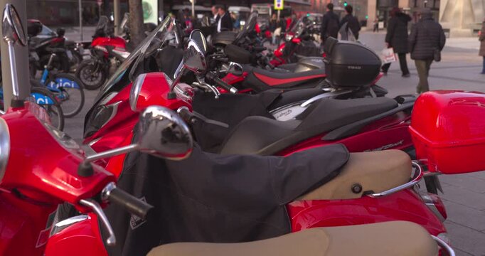 A red motorcycle is parked next to a black motorcycle