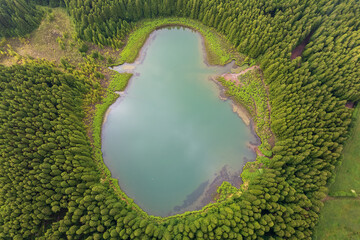 Naklejka premium Drone view of Canario Lagoon. Lake formed by the crater of an old volcano in San Miguel island, Azores, Portugal. Scenic landscape. Ghost shape aerial illusion.