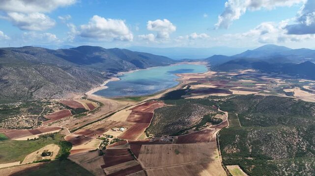 Aerial drone cinematic video of artificial lake of Yliki in Boeotia prefecture with calm waters and beautiful clouds, an important source of drinking water for the Athens, Greece