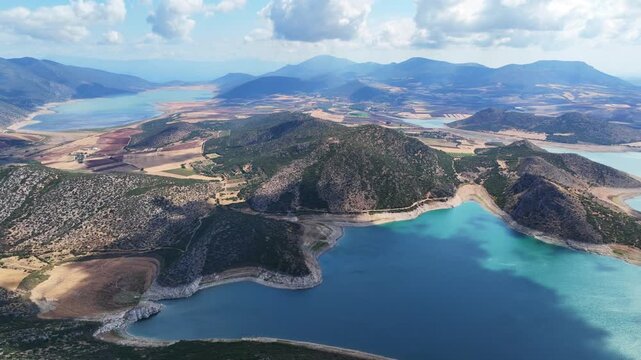 Aerial drone cinematic video of artificial lake of Yliki in Boeotia prefecture with calm waters and beautiful clouds, an important source of drinking water for the Athens, Greece