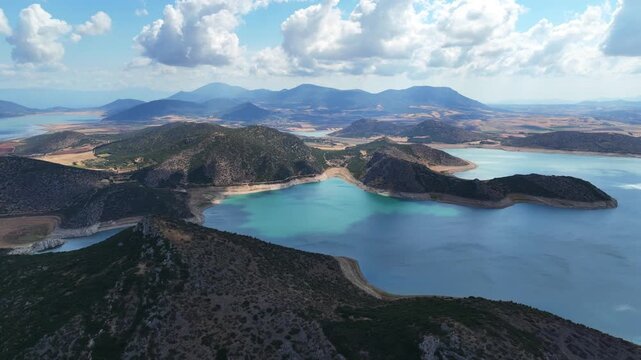 Aerial drone cinematic video of artificial lake of Yliki in Boeotia prefecture with calm waters and beautiful clouds, an important source of drinking water for the Athens, Greece