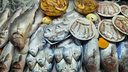 Fresh fish and seafood displayed at a market stall representing healthy nutrition food industry fishing trade