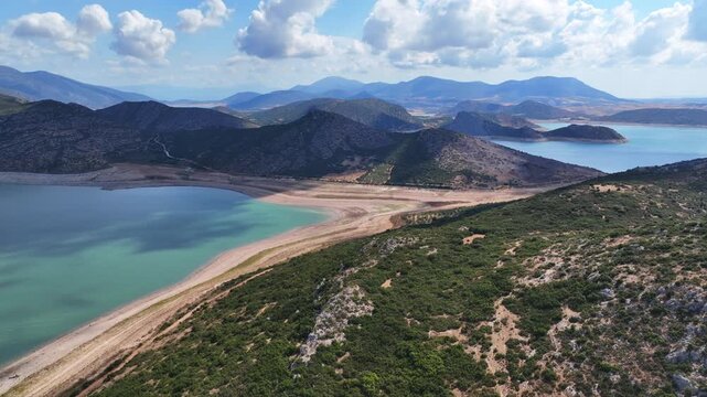 Aerial drone cinematic video of artificial lake of Yliki in Boeotia prefecture with calm waters and beautiful clouds, an important source of drinking water for the Athens, Greece
