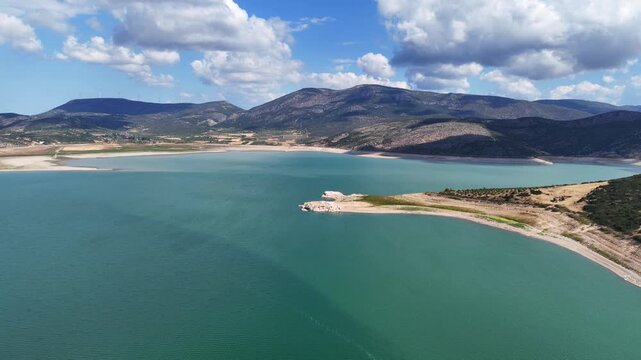 Aerial drone cinematic video of artificial lake of Yliki in Boeotia prefecture with calm waters and beautiful clouds, an important source of drinking water for the Athens, Greece