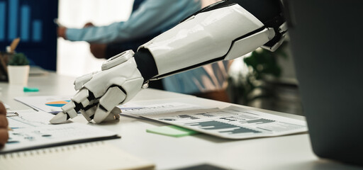 A stunning scene highlighting a robotic arm interacting with human colleagues in a modern office. The image emphasizes teamwork and innovation in the tech-driven workspace.Noogenesis