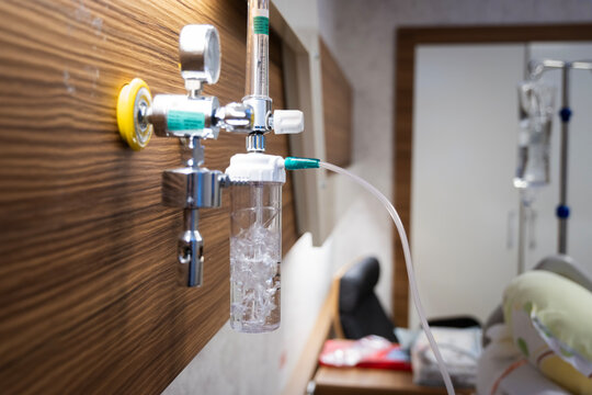 Medical oxygen flow meter system providing respiratory support and humidified therapy to a patient in a contemporary hospital room, ensuring critical care and recovery