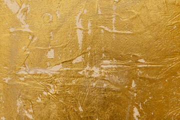 Abstract background. Textured Gold Venetian plaster Surface with Shimmering Highlights.
