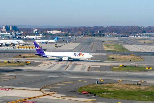 Newark Liberty Airport, Newark, New Jersey, USA - November 16, 2023 - A wide bodied FedEx Boeing 767-300F  cargo plane on the taxi way at EWR 