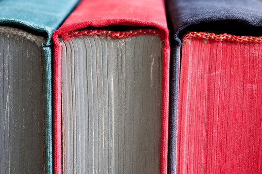 Close-up vintage books. Macro view colored pages spines covers. 