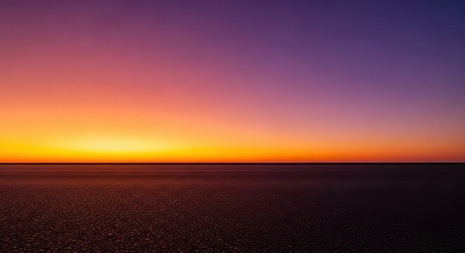 Vast empty dark asphalt floor or ground surface meeting a brilliant orange and purple sunset sky on the dramatic horizon line, surface, dramatic, street