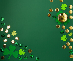 St. Patrick's Day Leprechaun Hat, Gold Coins, Shamrocks and Party Favors on Green Background.