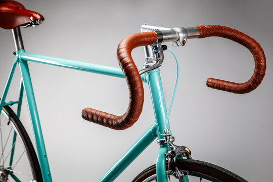 Hipster fixed-gear bike standing on white background, close-up