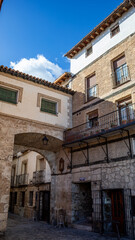 Fototapeta premium Entrance arch to the Plaza de la Hora with the Ducal Palace in Pastrana, Guadalajara, Castilla-La Mancha, Spain