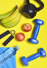 Activity and good nutrition, represented by sports accessories and fruit. Take care of yourself and stay healthy. Zenith view and vertical shot.