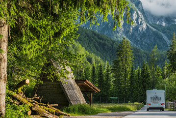 Slovenian Mountain Road With Cabin and Vehicle in Forest