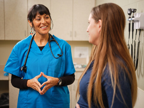 Native American nurse helps Native woman in a clinic