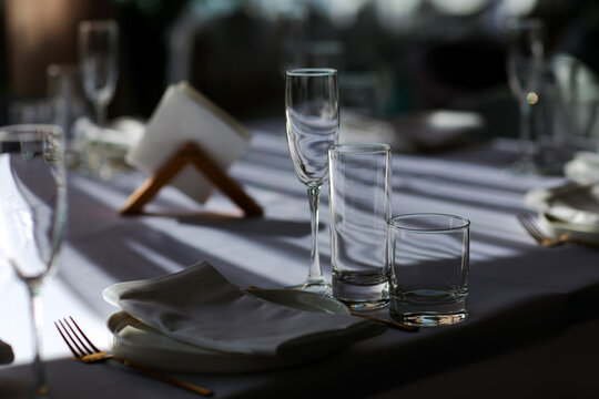 Beautiful table setting with dishes,in a restaurant,light-shadow pattern and style