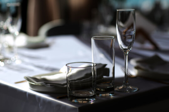 Beautiful table setting with dishes,in a restaurant,light-shadow pattern and style