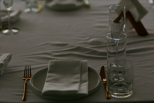 Beautiful table setting with dishes,in a restaurant,light-shadow pattern and style