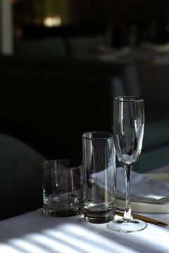 Beautiful table setting with dishes,in a restaurant,light-shadow pattern and style