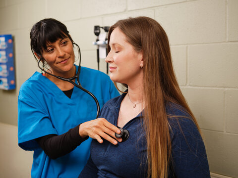 Indigenous nurse conducting auscultation for a routine cardiac exam