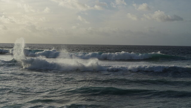 Spectacular sunset contemplating the force of the sea crashing agains the cliff