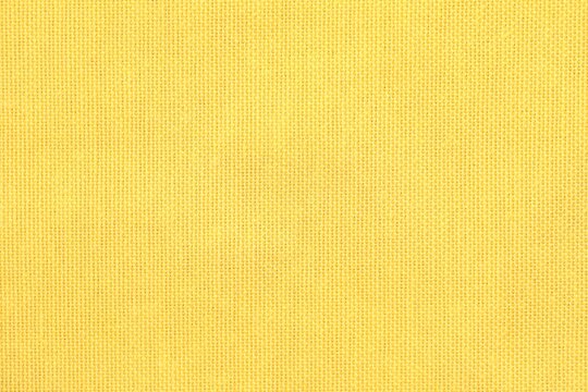 Texture of yellow fabric as background, top view