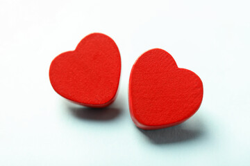 Obraz premium Love. Red decorative hearts on light blue background, closeup