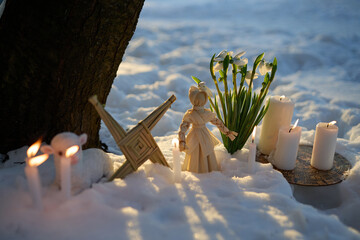 Imbolc pagan ritual with brigid's cross in snow