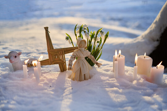 Imbolc brigid cross ritual with candles and snowdrops