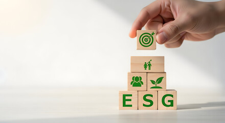 Hand Stacking Wooden Blocks with ESG Icons for Sustainability Concept environment social
