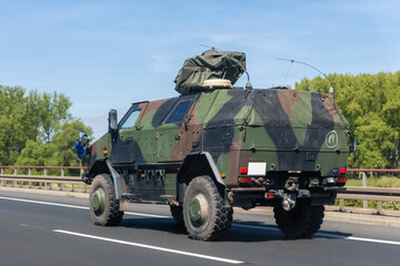 German military truck camouflage drives along autobahn green forest landscape during summer...
