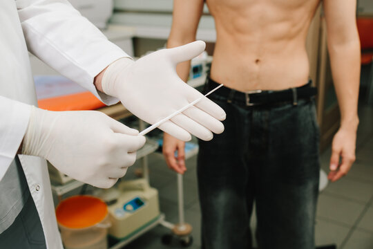 Patient genitourinary exam by urologist with sterile swab.