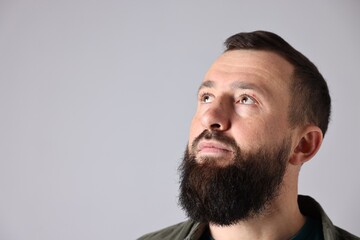 Obraz premium Man with mustache and beard on light grey background. Space for text