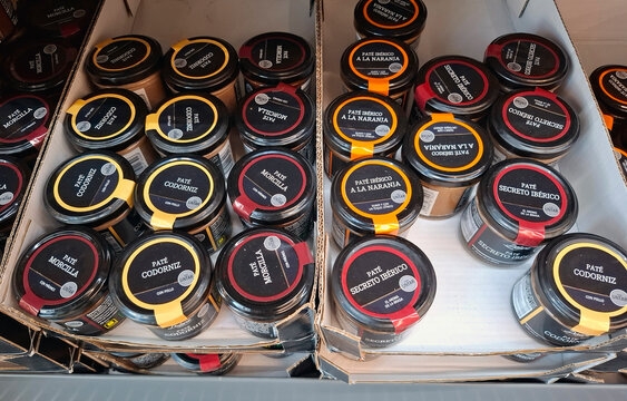 Display of specialty spreads and pates in a store in Spain with various flavors and types organized neatly on the shelves