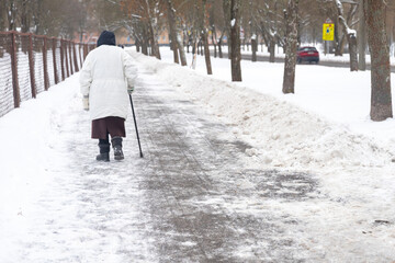 Old woman practicing Nordic pole walking, active lifestyle. Woman trekking with walking sticks