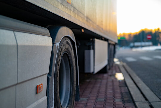 Details of truck chassis and wheel arch, professional commercial vehicle at a rest area.